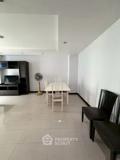 Spacious living room with modern dining area and sleek furniture.