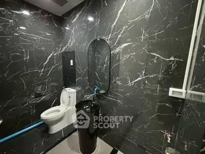 Luxurious black marble bathroom with modern fixtures and elegant design