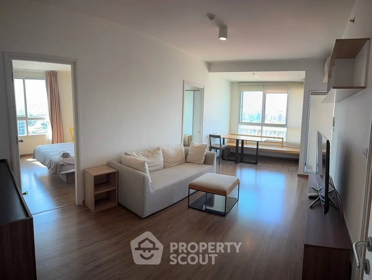 Spacious modern living room with wooden flooring and natural light