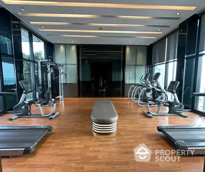 State-of-the-art gym with modern equipment and expansive windows in a luxury high-rise, perfect for fitness enthusiasts.