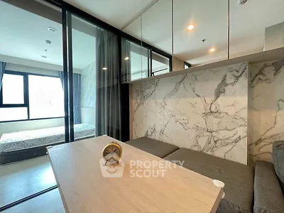 Modern living room with marble accent wall and cozy seating area