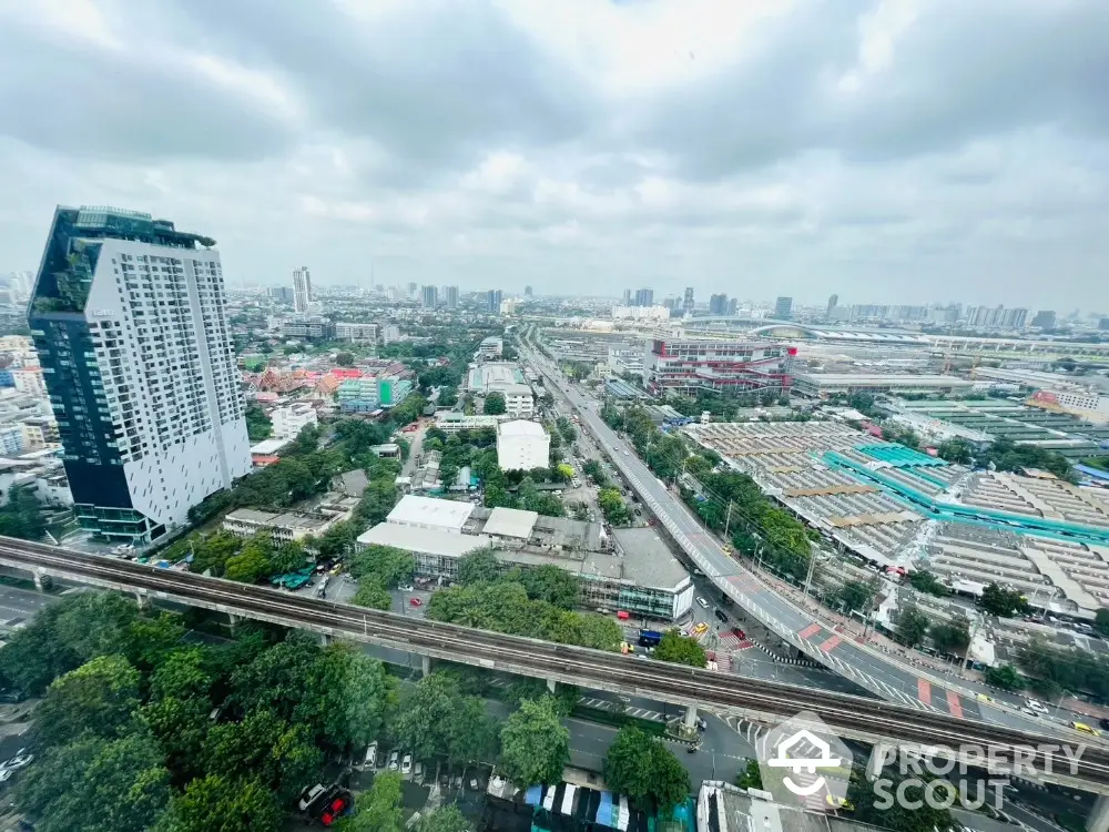 Stunning cityscape view from high-rise building showcasing urban skyline and transportation network.