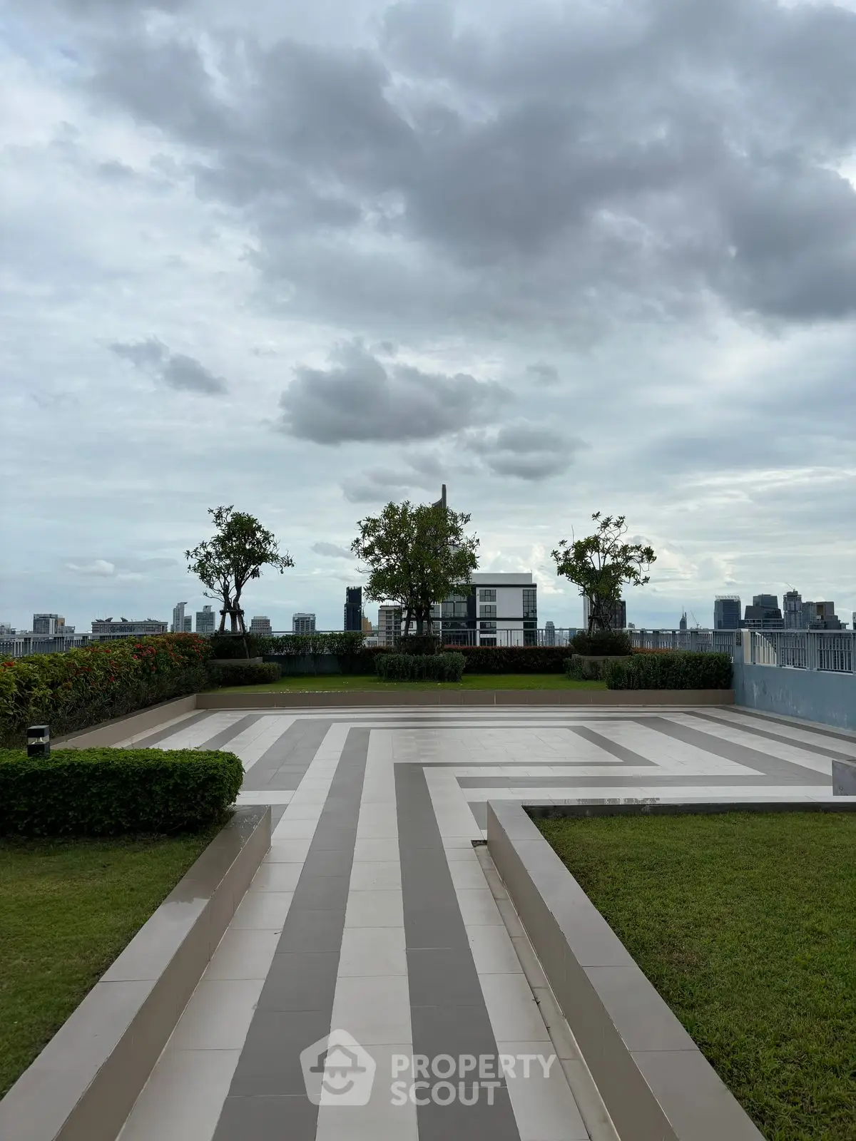 Stunning rooftop terrace with panoramic city views and lush greenery.
