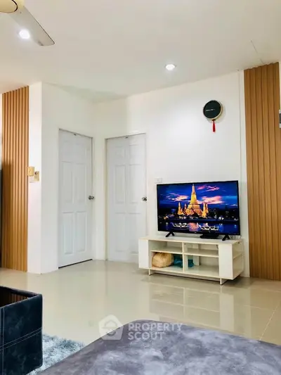 Modern living room with stylish decor and wall-mounted TV