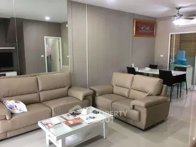 Spacious living room with modern furniture, glossy tiled flooring, and neutral color palette, perfect for family gatherings and relaxation.