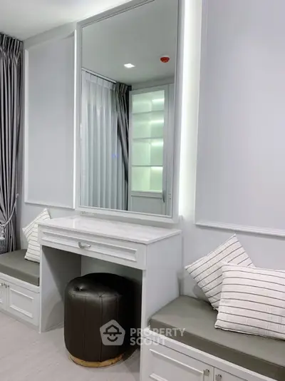 Elegant modern bedroom with built-in vanity and seating area