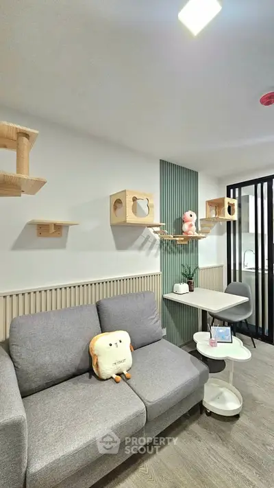Modern living room with stylish cat shelves and cozy gray sofa, perfect for pet lovers.