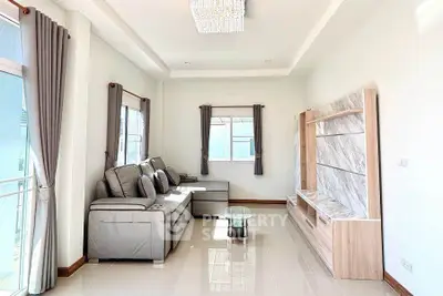 Spacious living room with modern gray sofa and elegant shelving unit