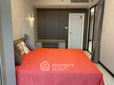 Modern bedroom with red bedspread and stylish decor