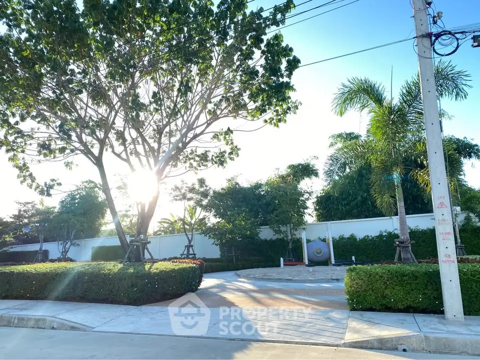 Beautiful residential entrance with lush greenery and morning sunlight