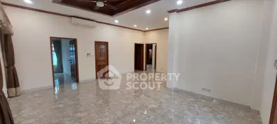 Spacious living room with marble flooring and elegant ceiling design