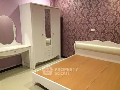 Elegant bedroom with stylish furniture and patterned wallpaper, perfect for modern living.
