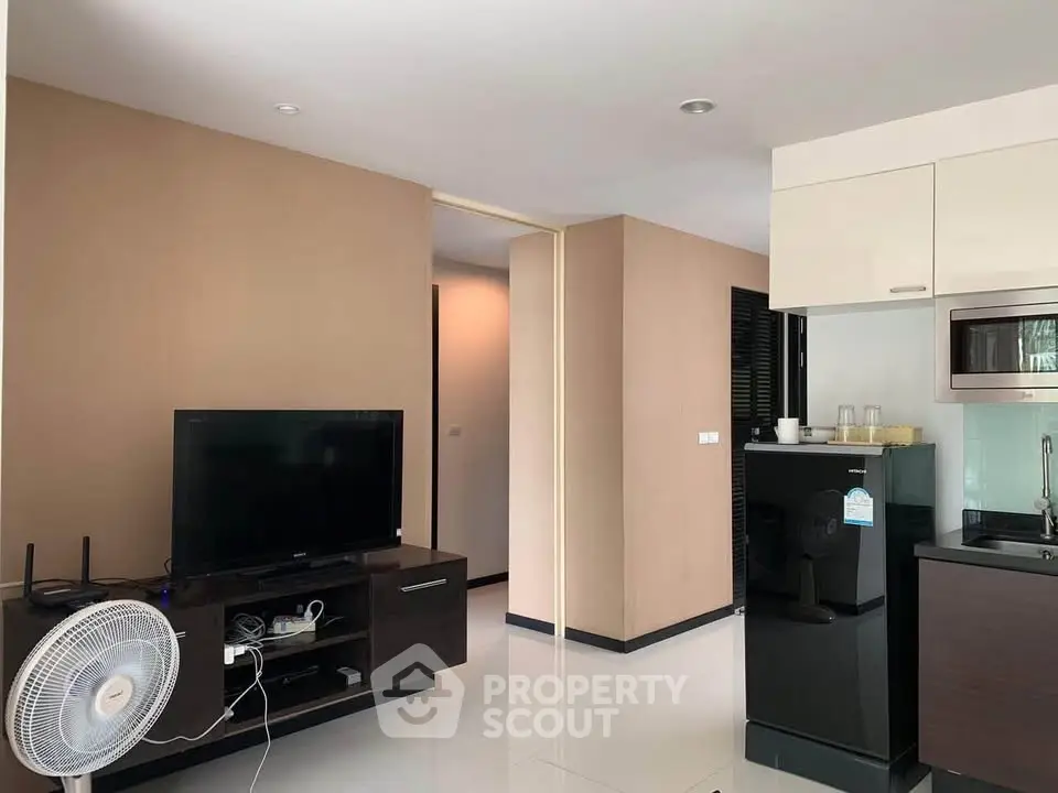 Modern living room with sleek kitchen and entertainment setup