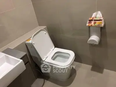 Modern bathroom with sleek toilet and minimalist design, perfect for contemporary living spaces.
