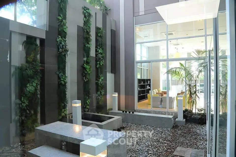 Modern indoor garden with sleek design and large glass windows, perfect for relaxation and natural light.