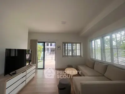 Spacious living room with modern decor and large windows for natural light.
