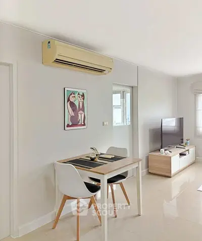 Modern living room with sleek furniture and air conditioning, perfect for cozy urban living.