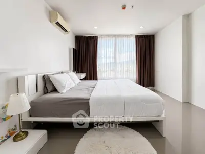 Spacious modern bedroom with large windows and elegant decor