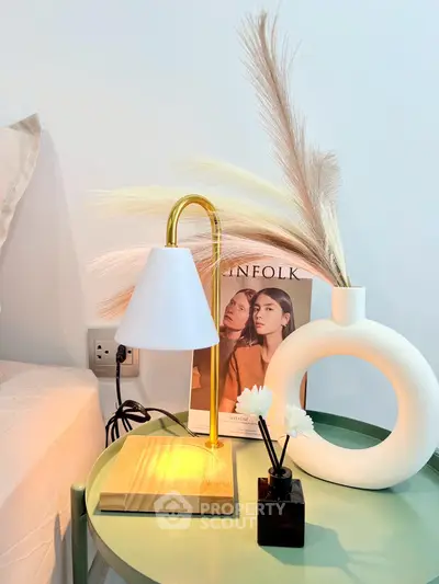 Stylish bedroom nightstand with modern lamp and decor accents