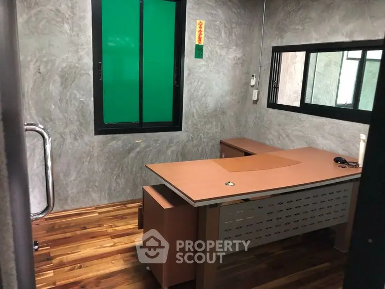 Modern study room with sleek desk and wooden flooring