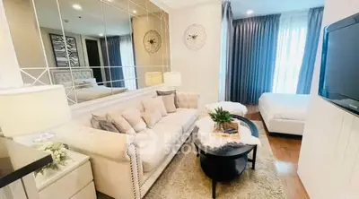 Elegant living room with plush sofa and modern decor in a cozy apartment setting.
