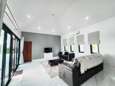 Spacious modern living room with high ceilings and elegant decor