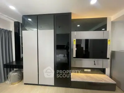 Modern interior with sleek built-in storage and entertainment unit in a stylish apartment.