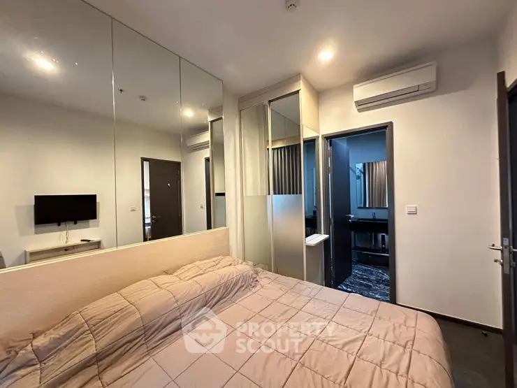 Modern bedroom with mirrored wall and air conditioning unit