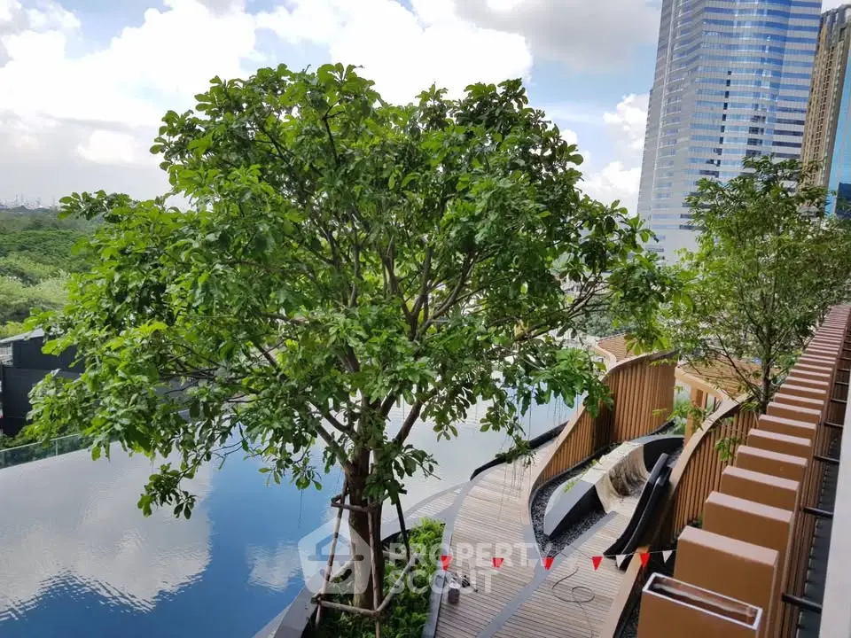 Luxurious rooftop pool with stunning city view and lush greenery, perfect for relaxation and leisure.