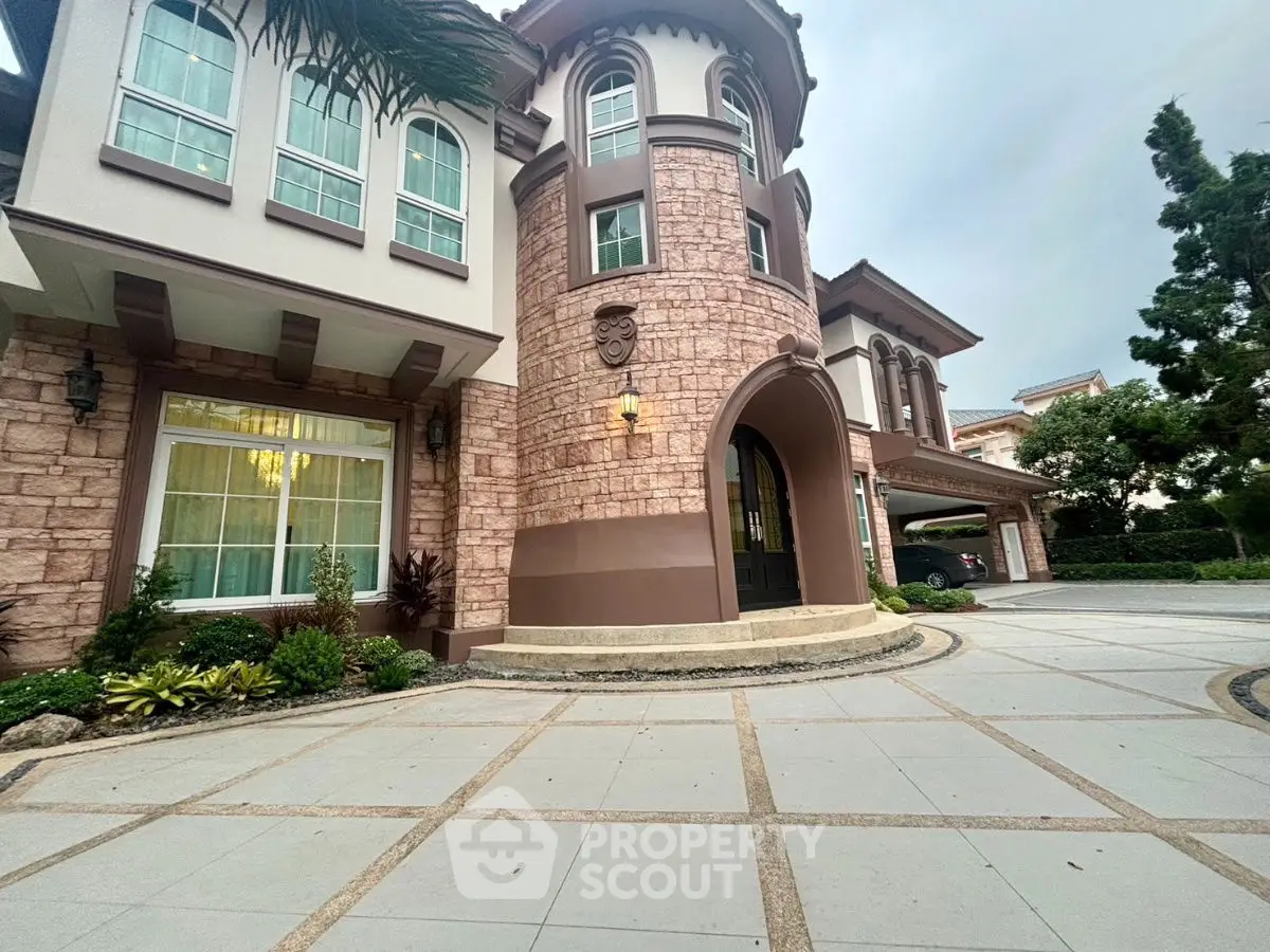 Luxurious mansion exterior with grand entrance and elegant stone facade
