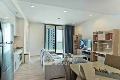 Modern living room with open kitchen and balcony view in luxury apartment