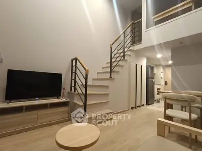 Modern duplex living room with stylish staircase and cozy furniture