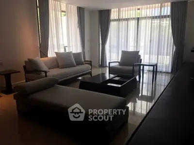 Elegant living room with modern furniture and large windows