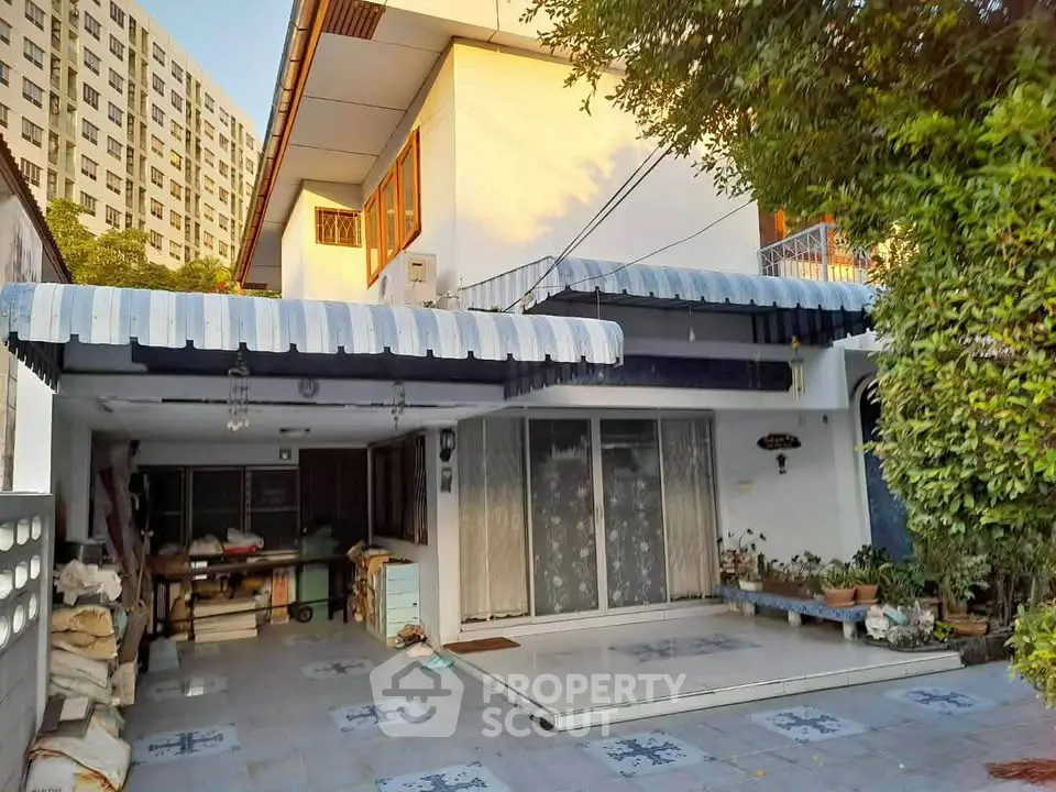 Charming suburban home with spacious patio and lush greenery, perfect for family living.