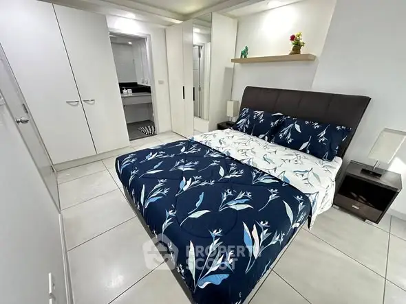 Modern bedroom with stylish decor and ensuite bathroom in a contemporary apartment.