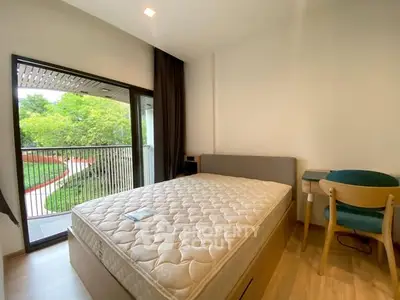 Cozy bedroom with balcony view and modern furnishings