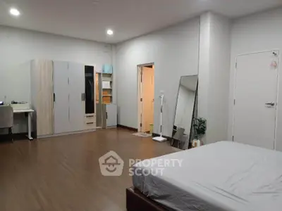 Spacious bedroom with modern furnishings and ample storage space