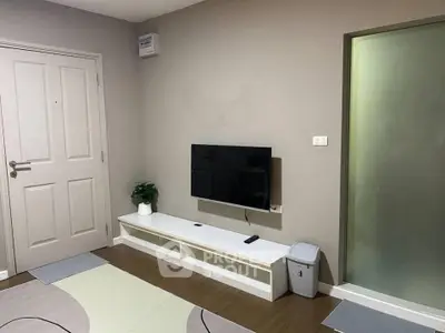 Modern living room with wall-mounted TV and minimalist decor