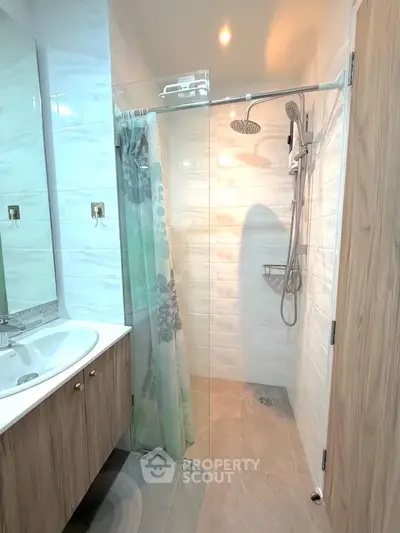 Modern bathroom with glass shower and wooden vanity