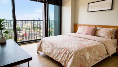 Spacious bedroom with stunning city view and elegant decor