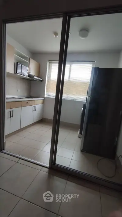 Modern kitchen with closed layout and large window for natural light