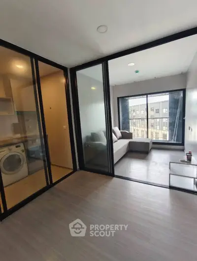 Modern apartment with glass partitions and cozy living area