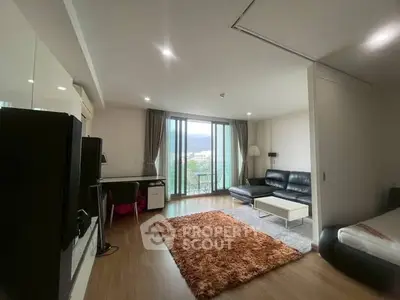 Spacious living room with modern decor and large windows offering scenic views.