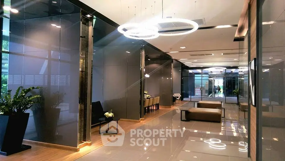 Luxurious modern building lobby with sleek design and elegant lighting fixtures.