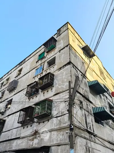 Vintage apartment building with balconies and urban charm, perfect for city living enthusiasts.
