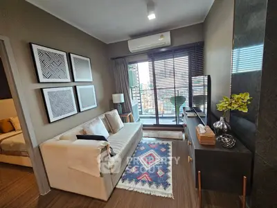 Modern living room with stylish decor and balcony view in a cozy apartment