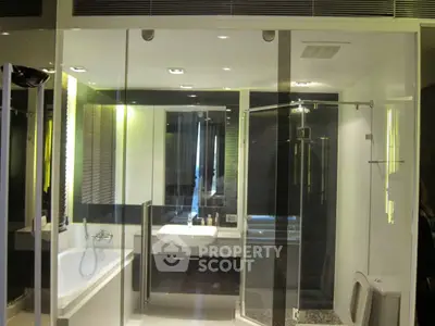 Luxurious modern bathroom with glass shower and bathtub in elegant design.
