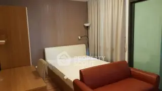 Cozy bedroom with modern furnishings and natural light