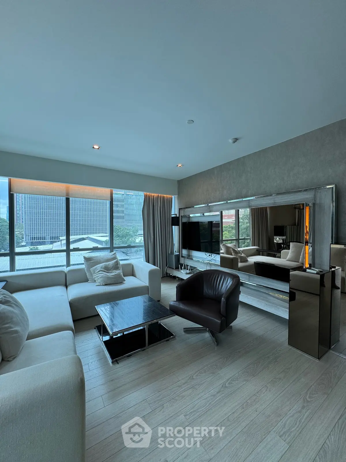 Luxurious modern living room with panoramic city view and elegant furnishings