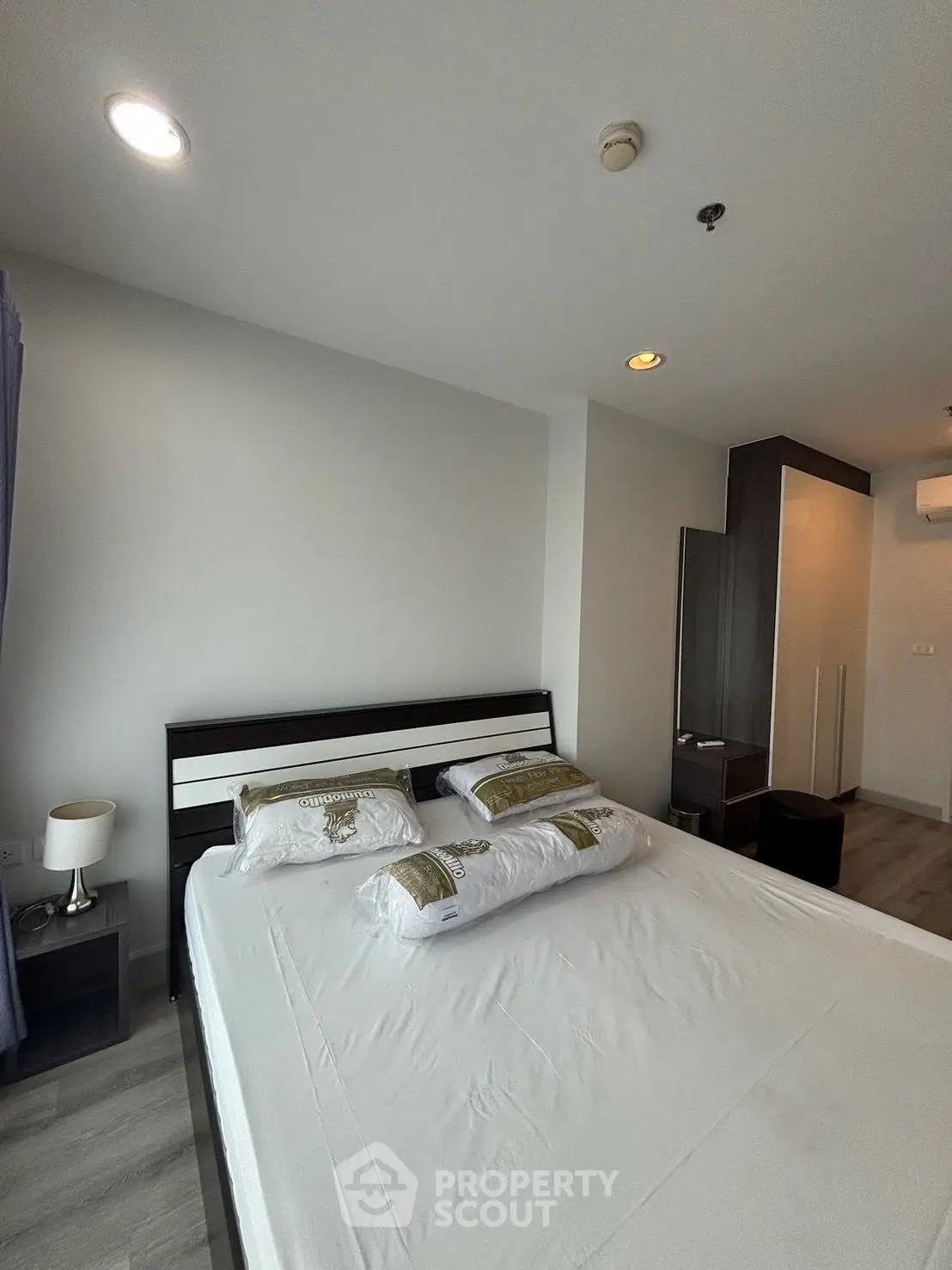 Spacious bedroom with modern decor and ample natural light